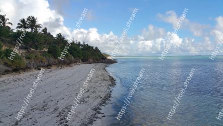 Body of water, Shore, Sea, Beach, Sky, Coast, Ocean, Tropics, Coastal and oceanic landforms, Cloud 