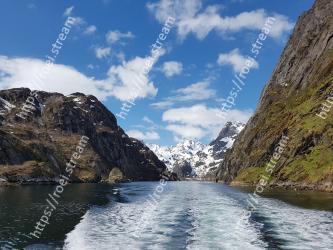 Mountainous landforms, Body of water, Mountain, Fjord, Natural landscape, Sky, Highland, Water, Mountain range, Water resources 