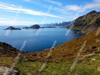Body of water, Coast, Mountain, Highland, Natural landscape, Mountainous landforms, Sky, Headland, Sea, Coastal and oceanic landforms 
