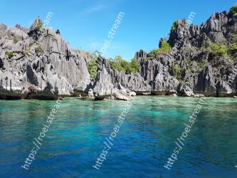 Body of water, Sea, Natural landscape, Coastal and oceanic landforms, Coast, Rock, Bay, Sky, Promontory, Turquoise 
