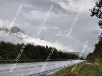 Sky, Cloud, Rainbow, Road, Natural landscape, Meteorological phenomenon, Highway, Highland, Atmospheric phenomenon, Tree 