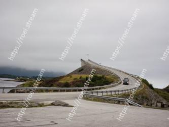 Sky, Atmospheric phenomenon, Road, Wall, Sea, Infrastructure, Cloud, Highland, Hill, Tree 